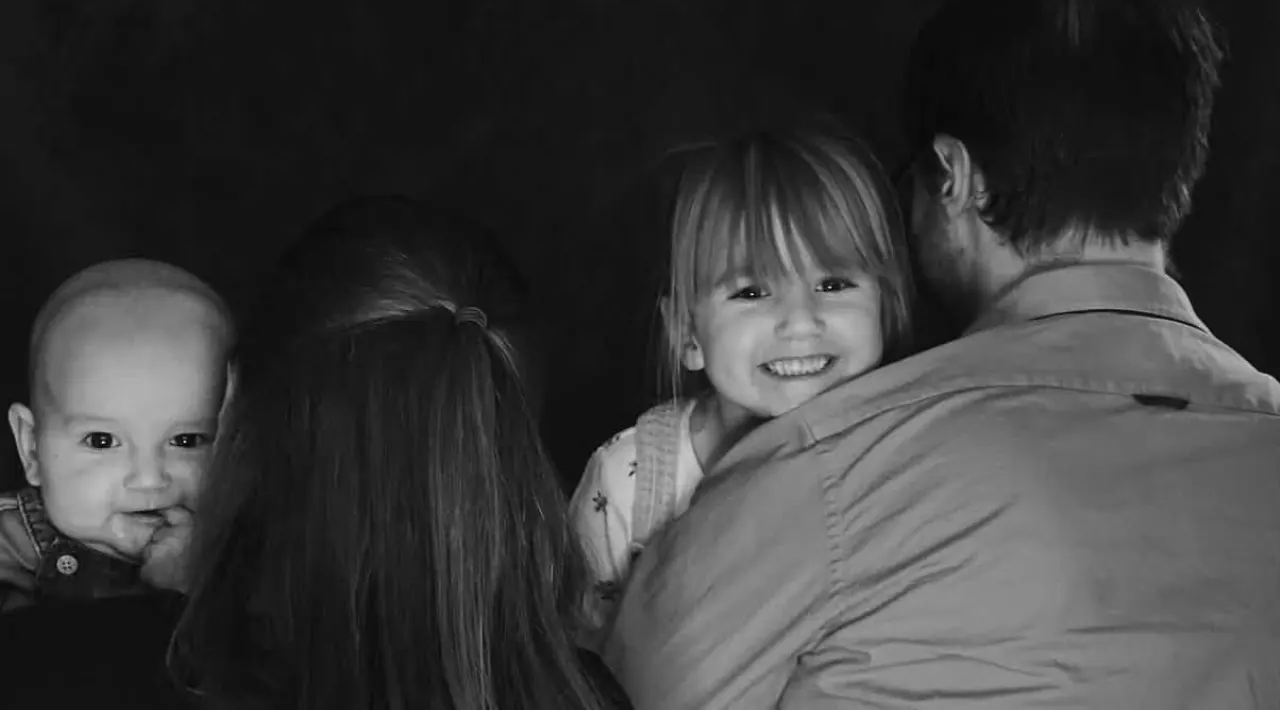 Family gathered together in a tender black and white portrait